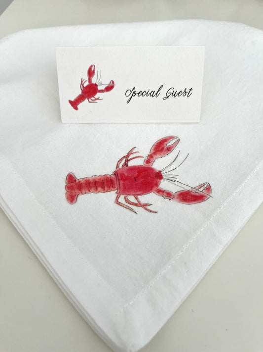 Red lobster illustrated on white cotton napkin with matching 'Special Guest' place card for coastal table settings