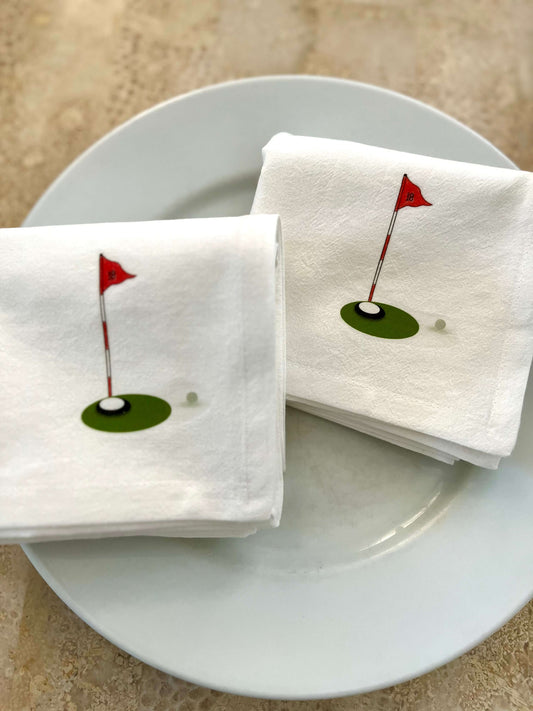 Golf Tournament Gift Set featuring elegant cotton napkins with golf flag design on a plate.