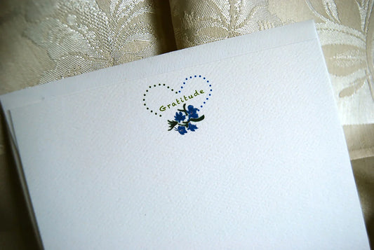 Eco-friendly note card with 'Gratitude' text, heart outline, blue flowers illustration by Happenstance Creations