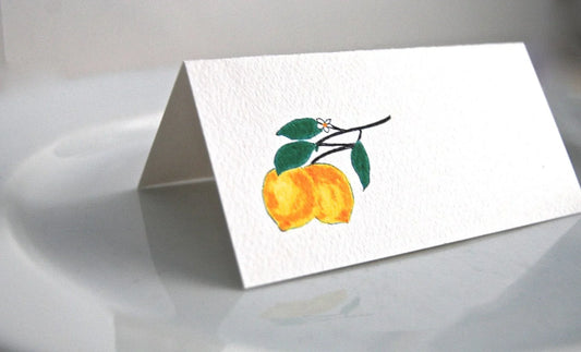Tented place card with hand-painted yellow lemons and green leaves illustration