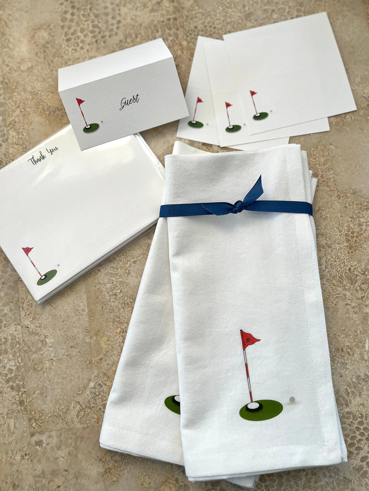 Golf-themed cotton napkins with red flag design, paired with matching place cards and thank you notes for elegant entertaining.