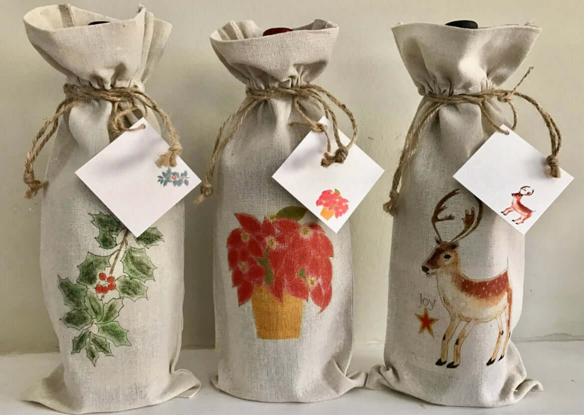 Holiday Linen Wine Bag Trio Set with Gift Card Set featuring holly, poinsettia, and reindeer designs.