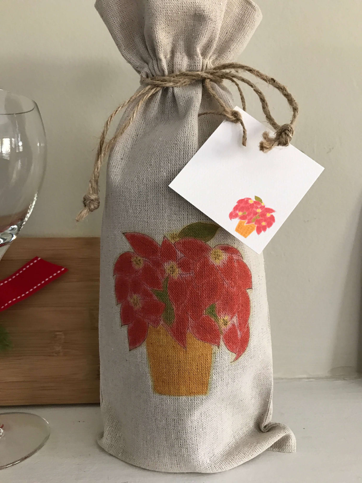 Holiday Linen Wine Bag Trio Set with Gift Card Set featuring a poinsettia design and matching gift card.
