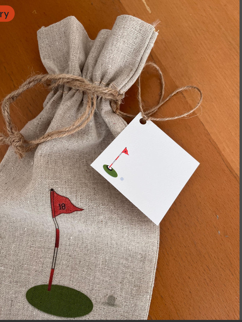 Linen gift bag with red golf flag illustration, rustic twine, and matching golf-themed tag
