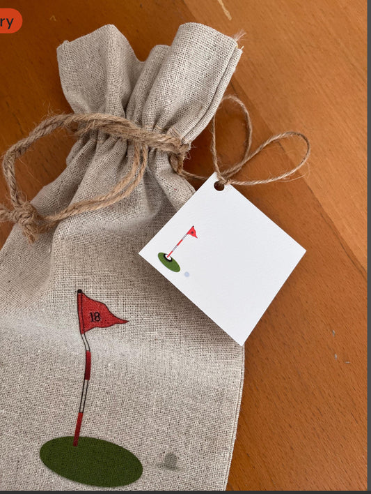 Linen gift bag with red golf flag illustration, rustic twine, and matching golf-themed tag