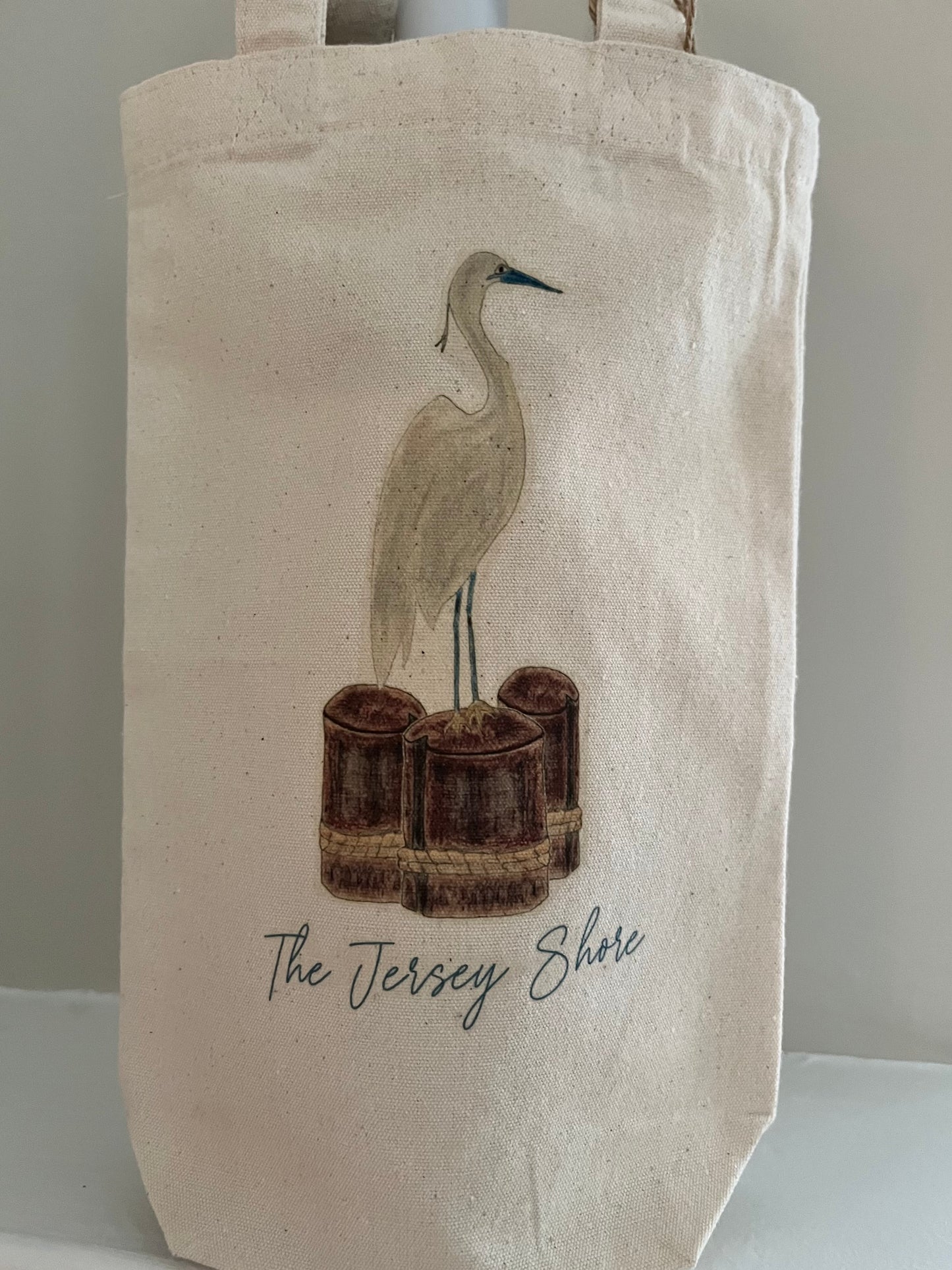 Canvas tote bag with heron illustration and The Jersey Shore text, coastal theme