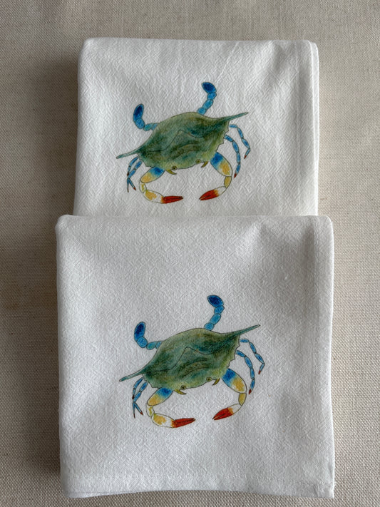 White cotton napkins with illustrated blue crab design, coastal kitchen linens